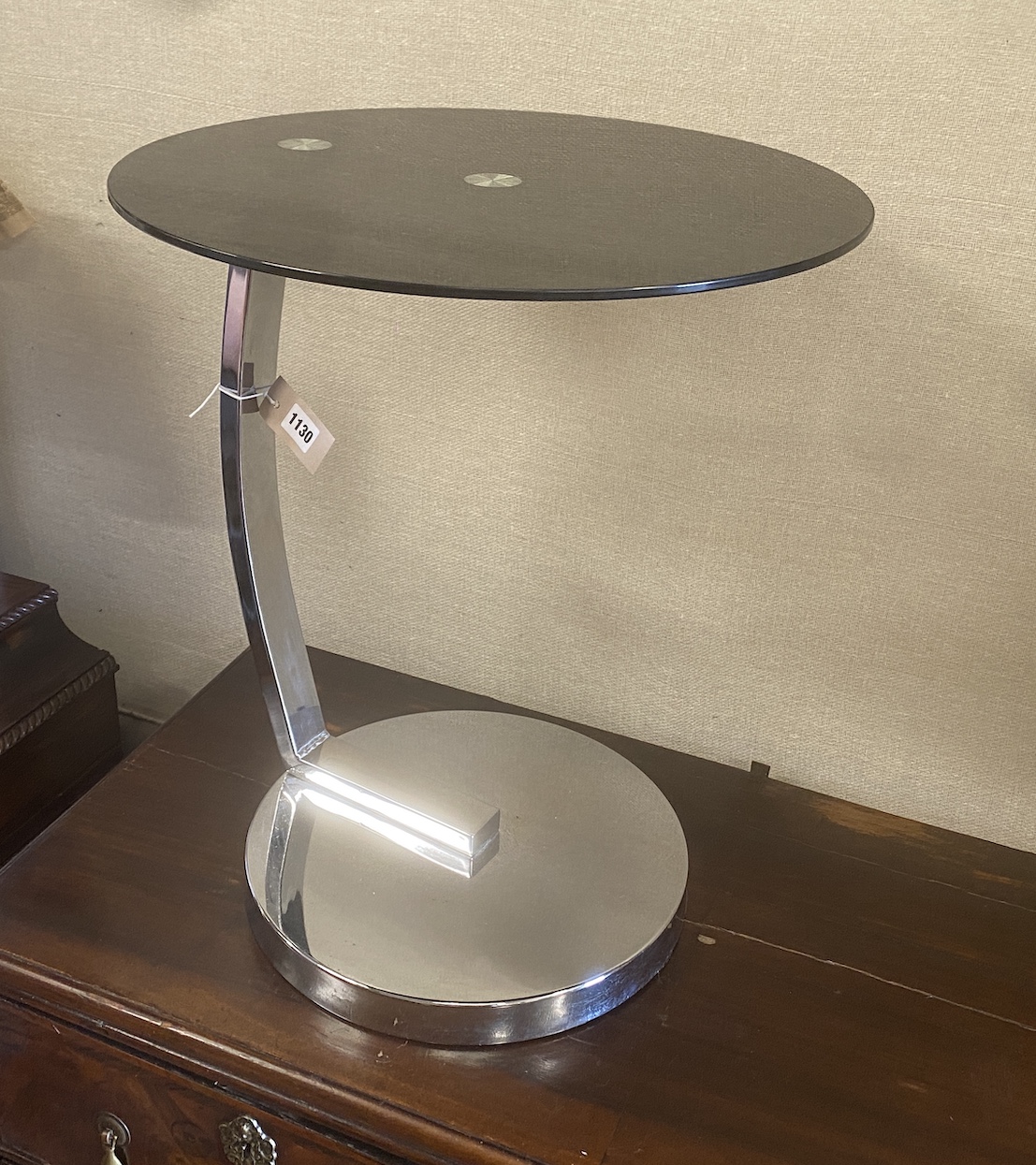 A chrome and black glass circular occasional table, diameter 45cm, height 54cm